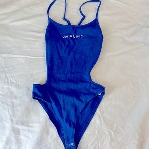 “Warning” body suit